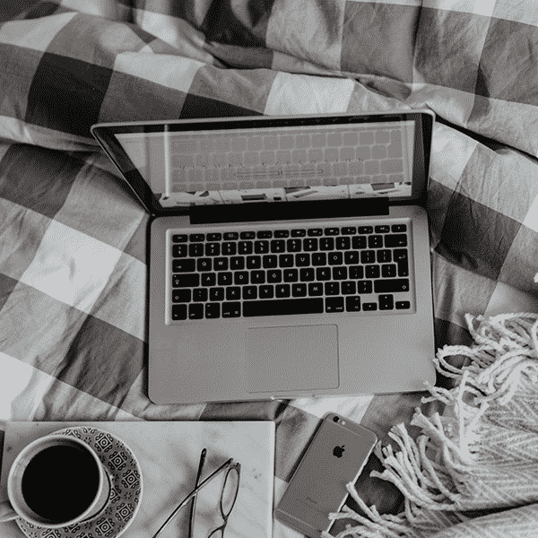 A laptop on a bed to show iMist are still working during self isolations